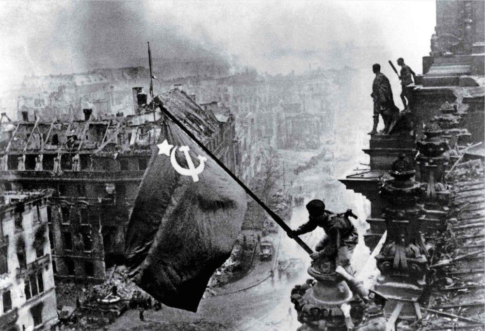 Soviet soldiers plant their flag atop the Reichstag