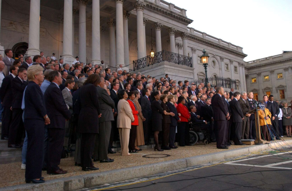 A photograph of a bipartisan and bicameral delegation of Congress on the Capitol steps on 9/11.